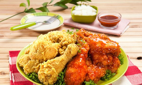 Korean fried chicken with crispy pieces and sauce